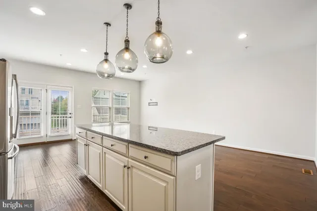 a kitchen with stainless steel appliances granite countertop a stove a refrigerator and a microwave