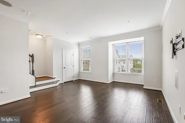 a view of a kitchen with a sink and wooden floor