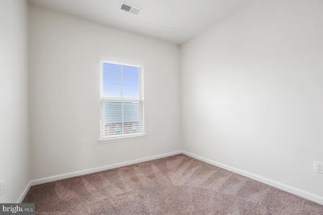 a view of an empty room and closet area