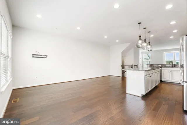 a view of a kitchen with stove and wooden floor
