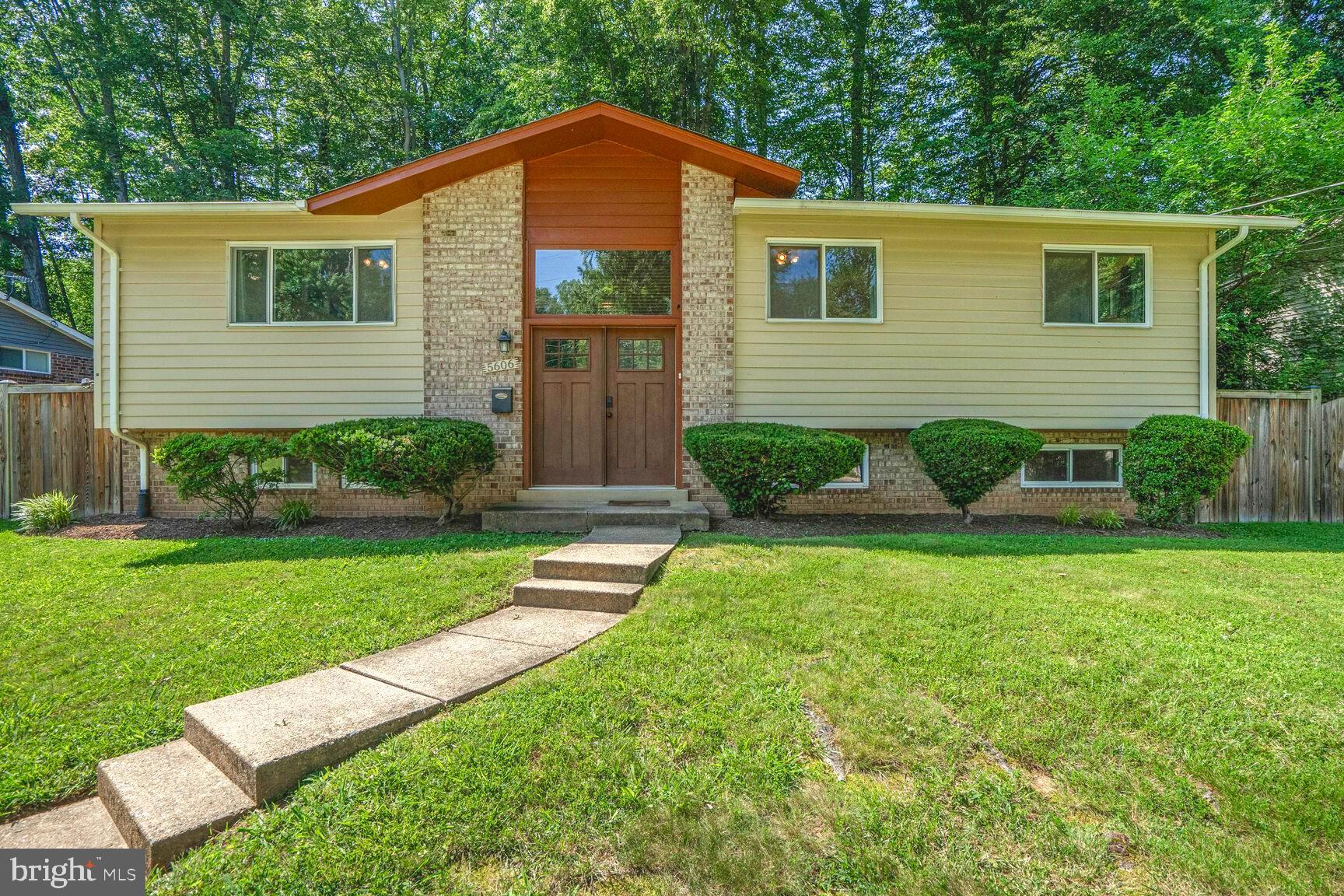 a view of backyard of house with green space
