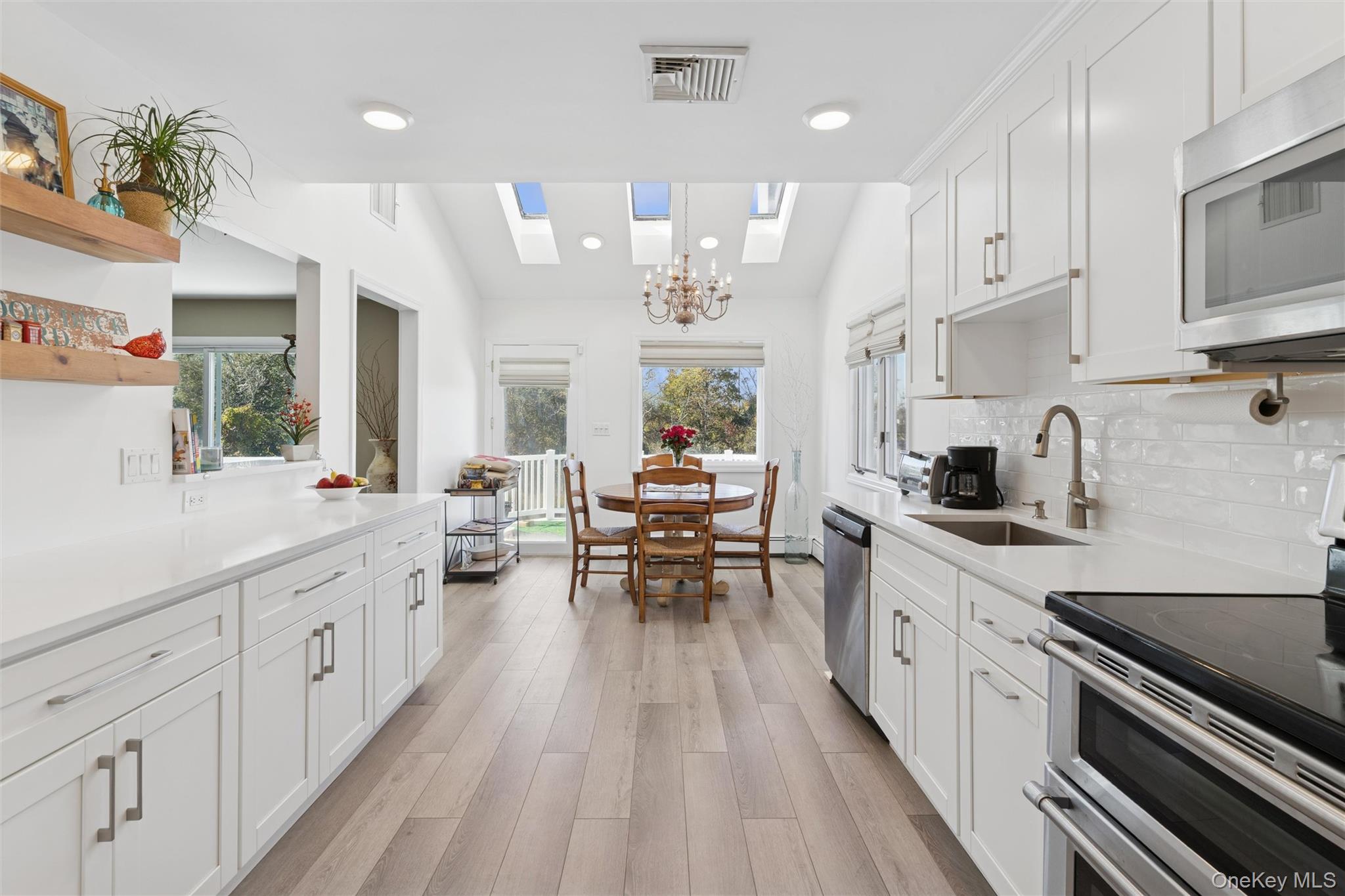 2858 Shore Road Bellmore, NY 11710 - Photo 11 of 38 a kitchen with stainless steel appliances kitchen island granite countertop a lot of counter space and wooden floors