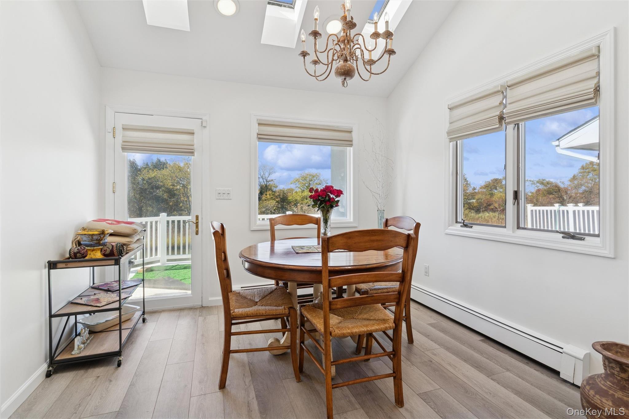 2858 Shore Road Bellmore, NY 11710 - Photo 12 of 38 a view of a dining room with furniture wooden floor and a chandelier