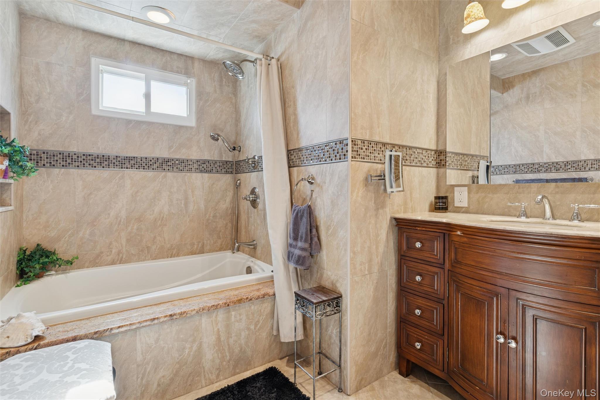 2858 Shore Road Bellmore, NY 11710 - Photo 13 of 38 a bathroom with a tub sink and mirror