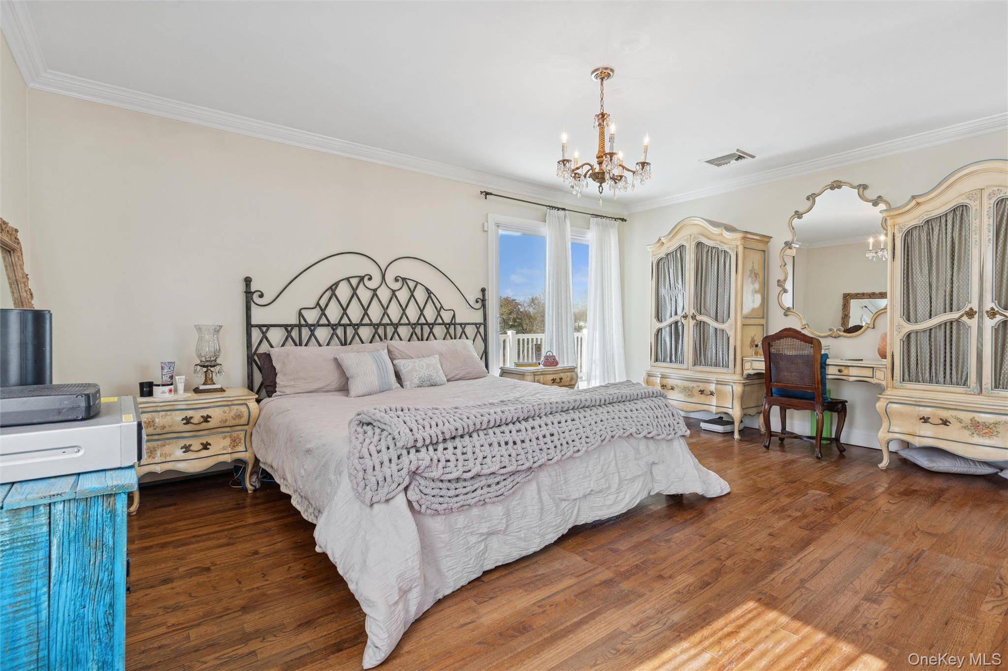 2858 Shore Road Bellmore, NY 11710 - Photo 14 of 38 a bedroom with bed and a chandelier