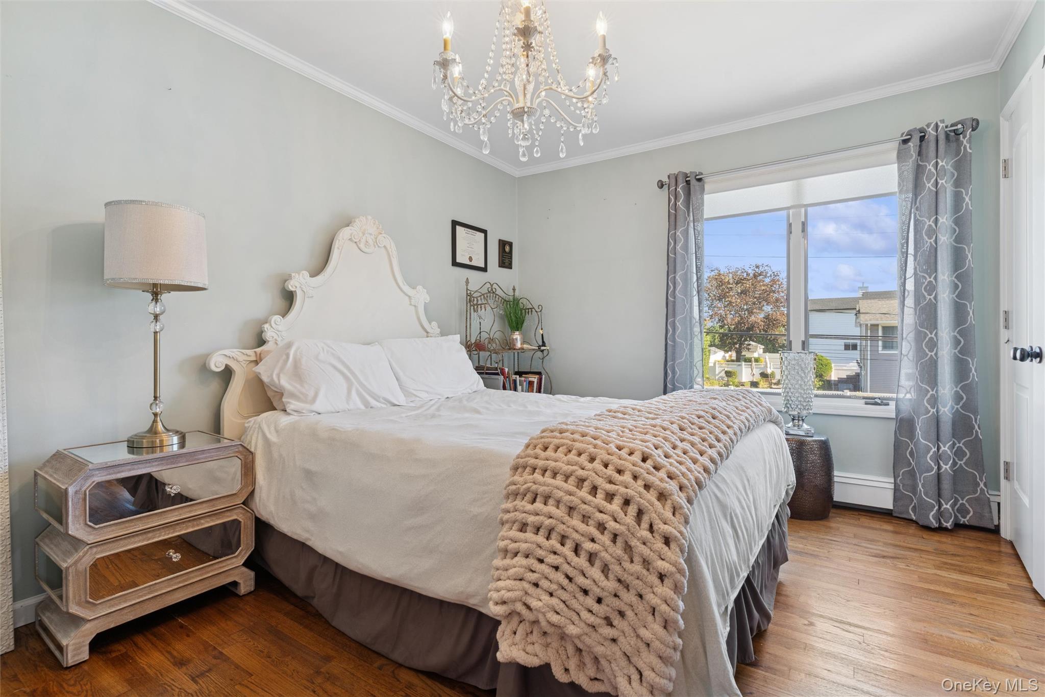 2858 Shore Road Bellmore, NY 11710 - Photo 17 of 38 a bedroom with a bed and a window