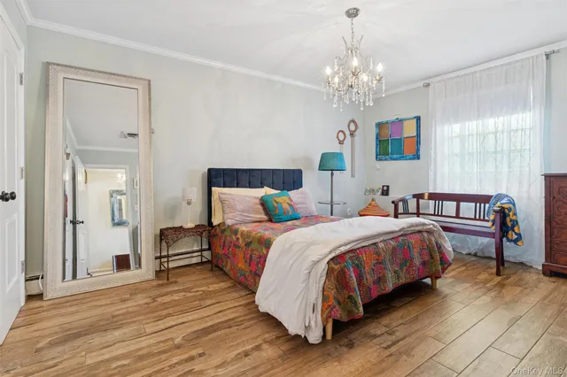 a bedroom with bed and a chandelier