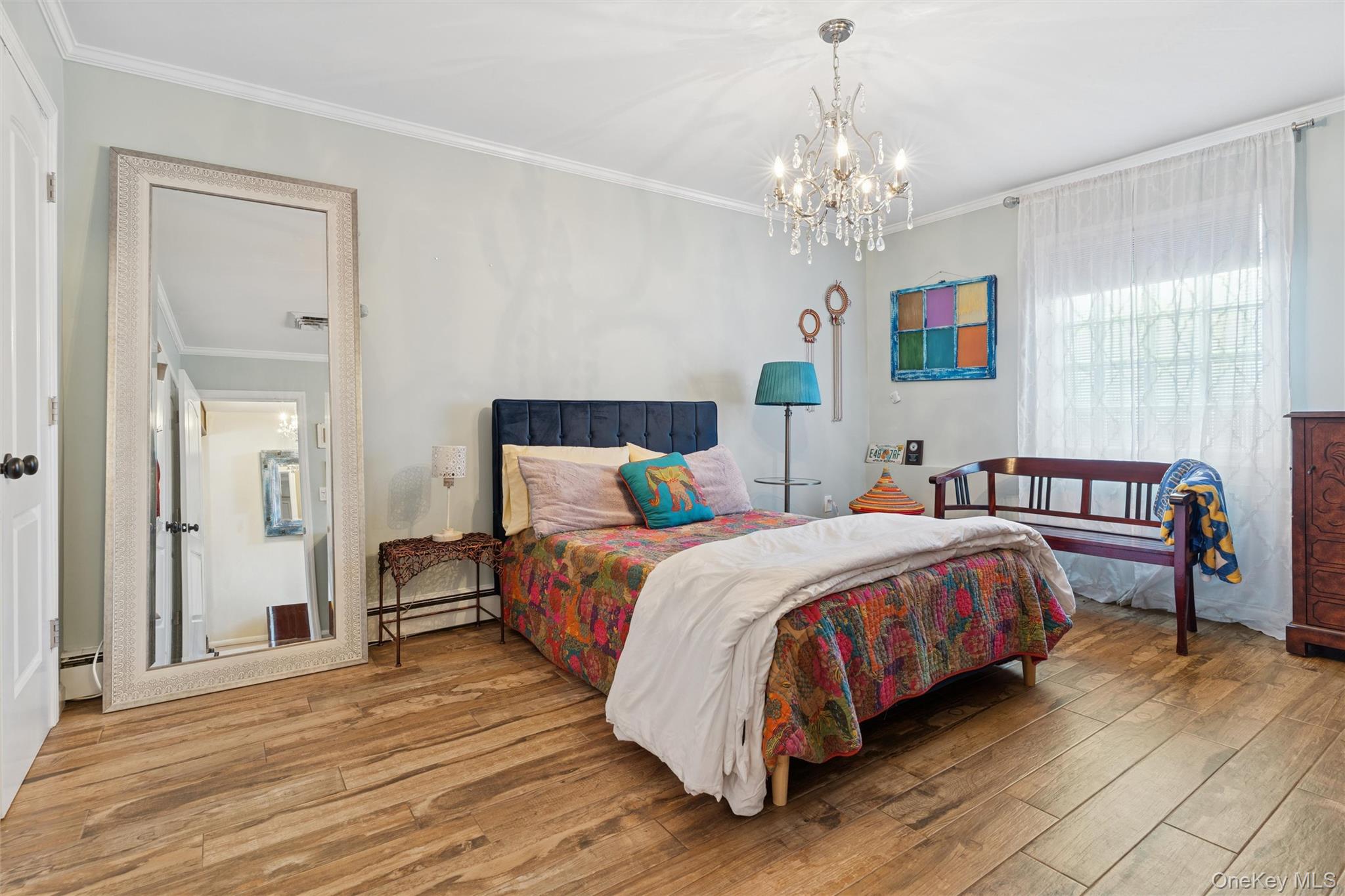 2858 Shore Road Bellmore, NY 11710 - Photo 19 of 38 a bedroom with bed and a chandelier