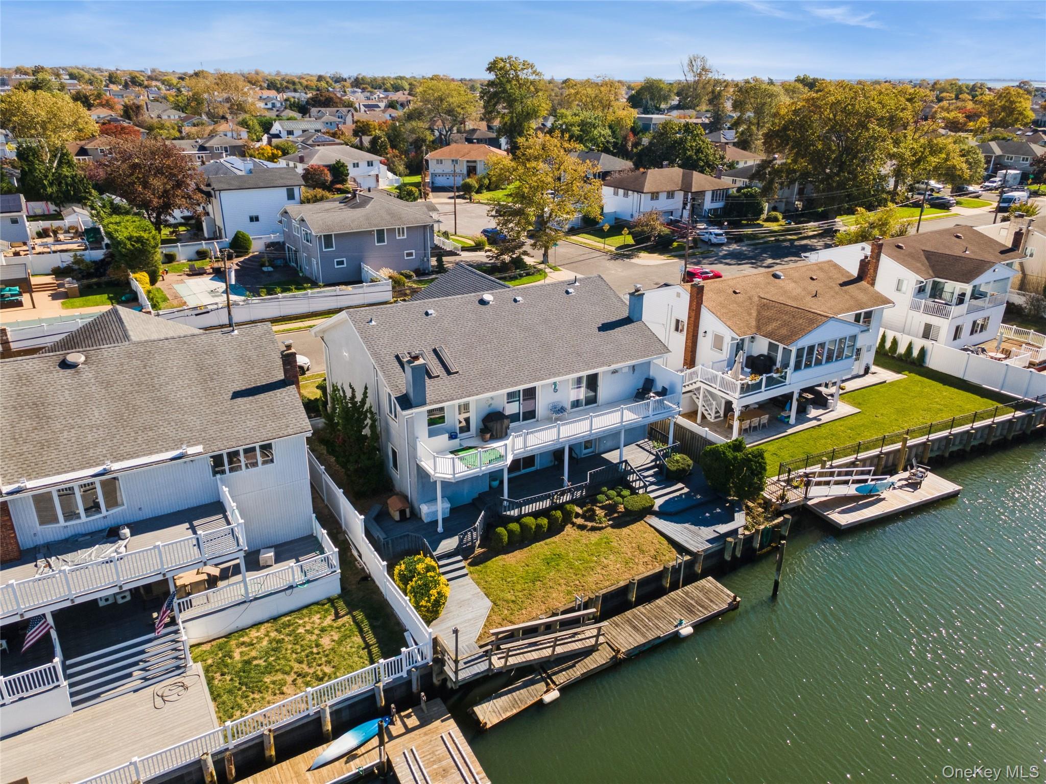 2858 Shore Road Bellmore, NY 11710 - Photo 2 of 38 an aerial view of a house with a swimming pool yard and outdoor seating
