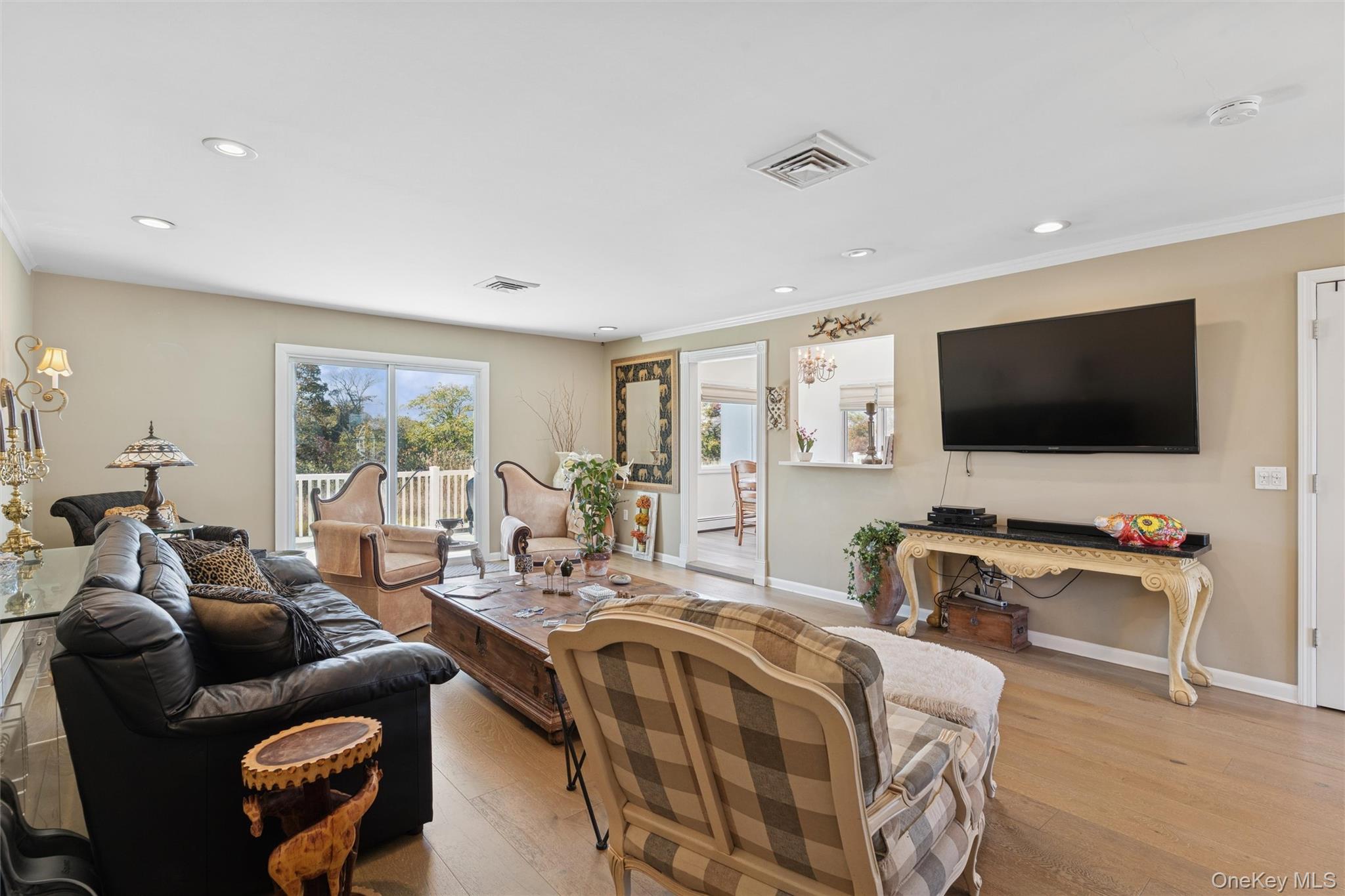 2858 Shore Road Bellmore, NY 11710 - Photo 6 of 38 a living room with furniture a flat screen tv and a large window