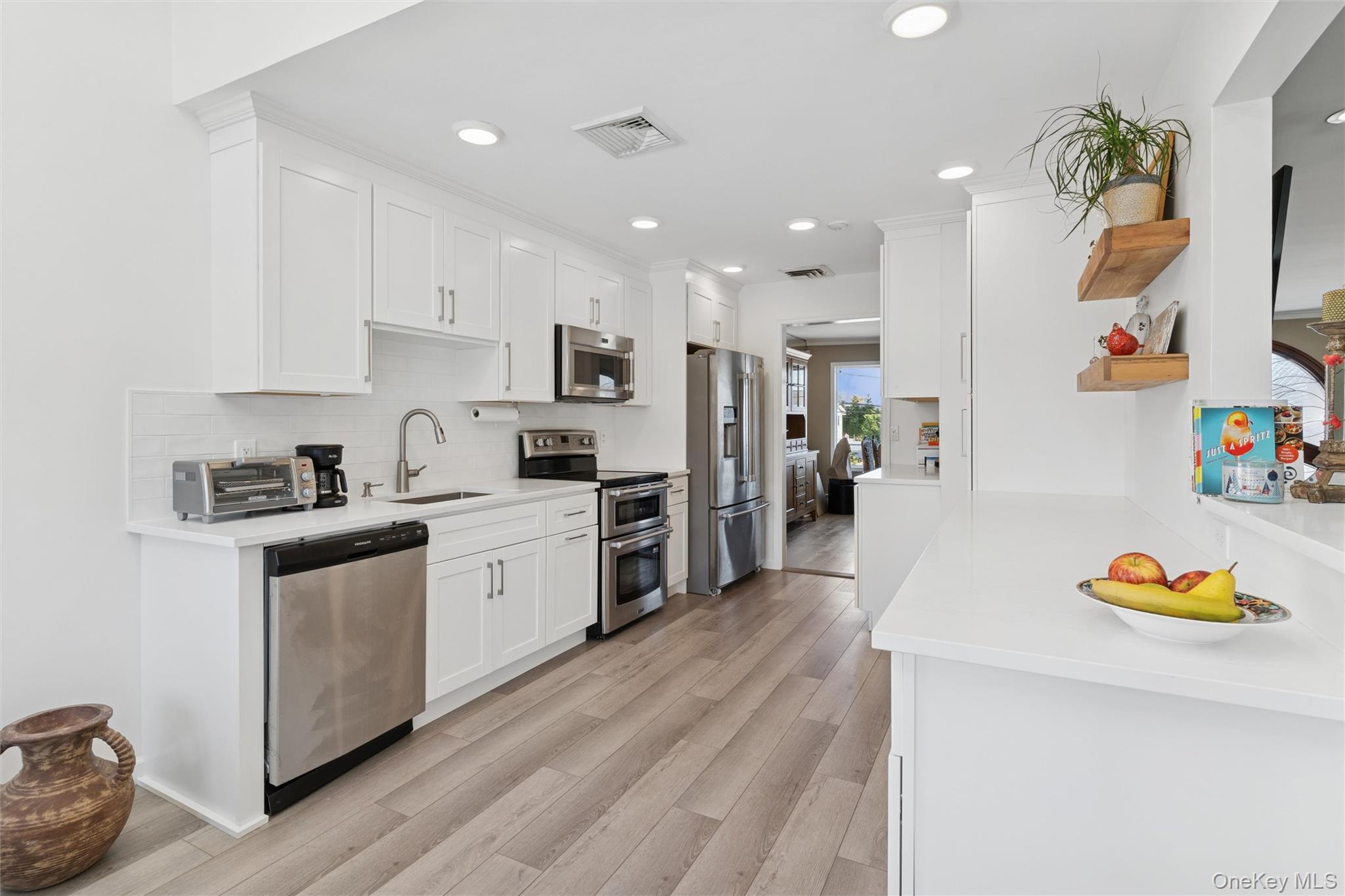 2858 Shore Road Bellmore, NY 11710 - Photo 8 of 38 a large kitchen with stainless steel appliances granite countertop a lot of counter space and wooden floor