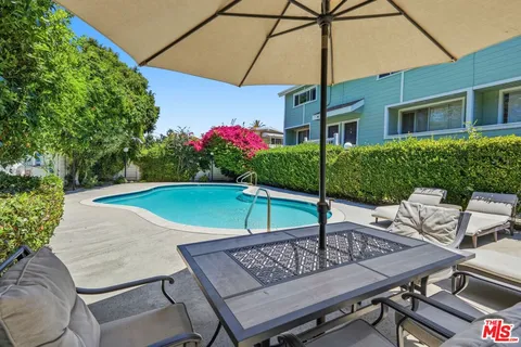 a patio with a table and chairs