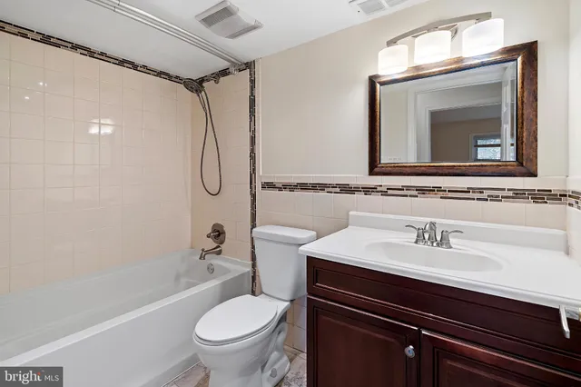 a bathroom with a sink a toilet and a bathtub