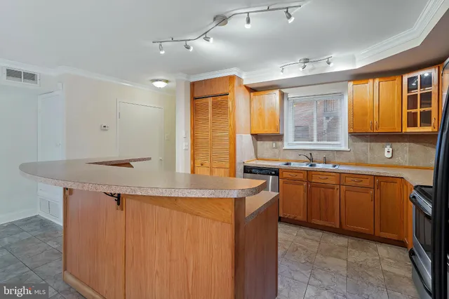 a kitchen with stainless steel appliances granite countertop a sink and a stove