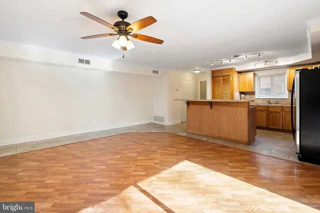 a view of a kitchen with a sink stainless steel appliances and cabinets