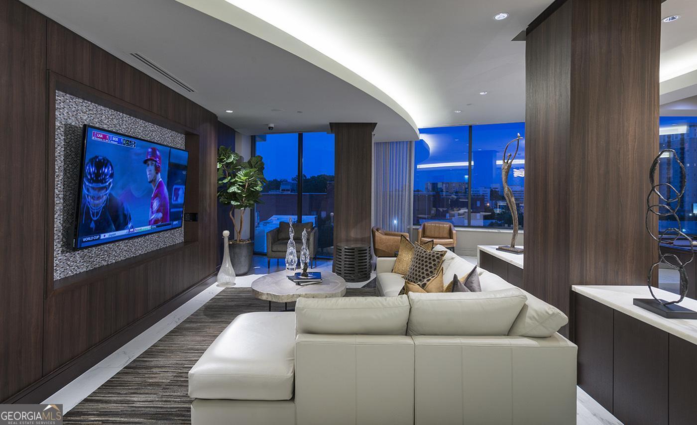 3150 Roswell Road Northwest, Unit 620 Atlanta, GA 30305 - Photo 17 of 26 a living room with furniture and a fireplace
