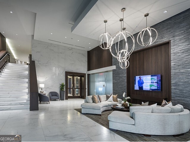 3150 Roswell Road Northwest, Unit 620 Atlanta, GA 30305 - Photo 22 of 26 a living room with furniture and a flat screen tv