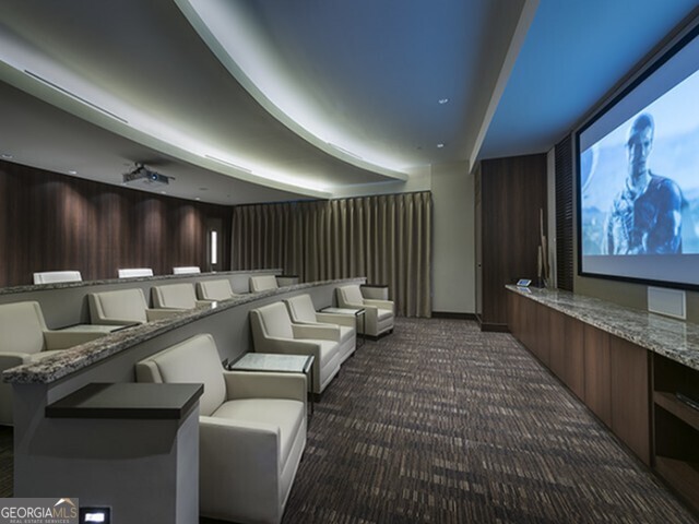 3150 Roswell Road Northwest, Unit 620 Atlanta, GA 30305 - Photo 8 of 26 a lobby with furniture and a flat screen tv