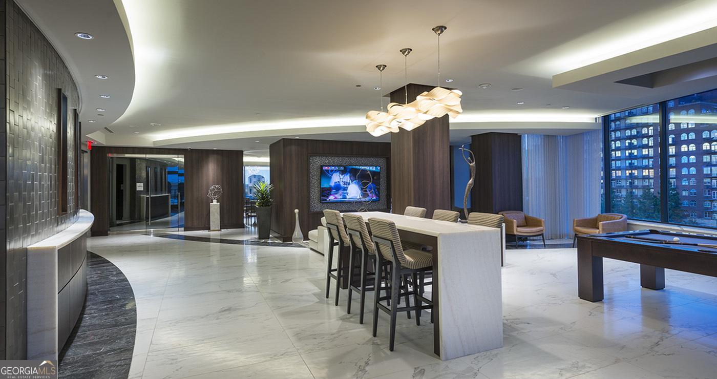 3150 Roswell Road Northwest, Unit 620 Atlanta, GA 30305 - Photo 10 of 26 a view of a dining room with furniture and chandelier