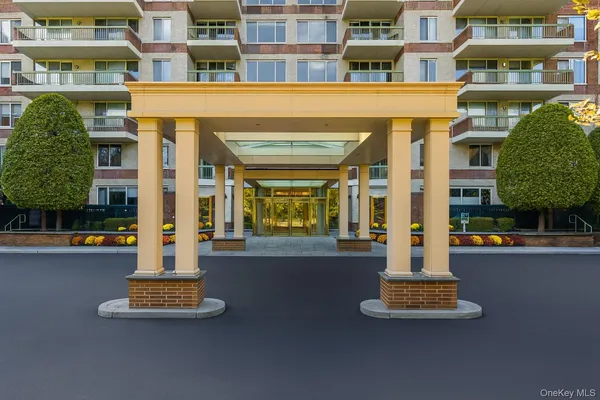 a front view of a building with a garden