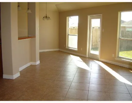 a view of an empty room with glass door