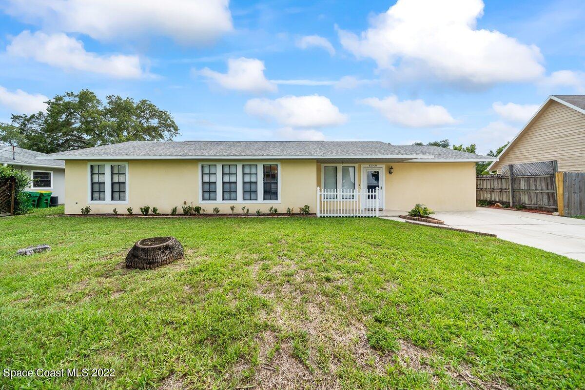 a front view of house with yard and green space