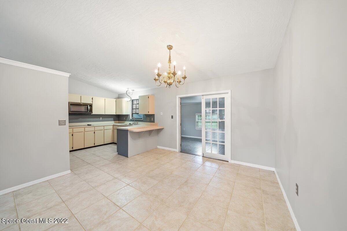 6840 Cairo Road Cocoa, FL 32927 - Photo 5 of 26 a large kitchen with a sink and cabinets