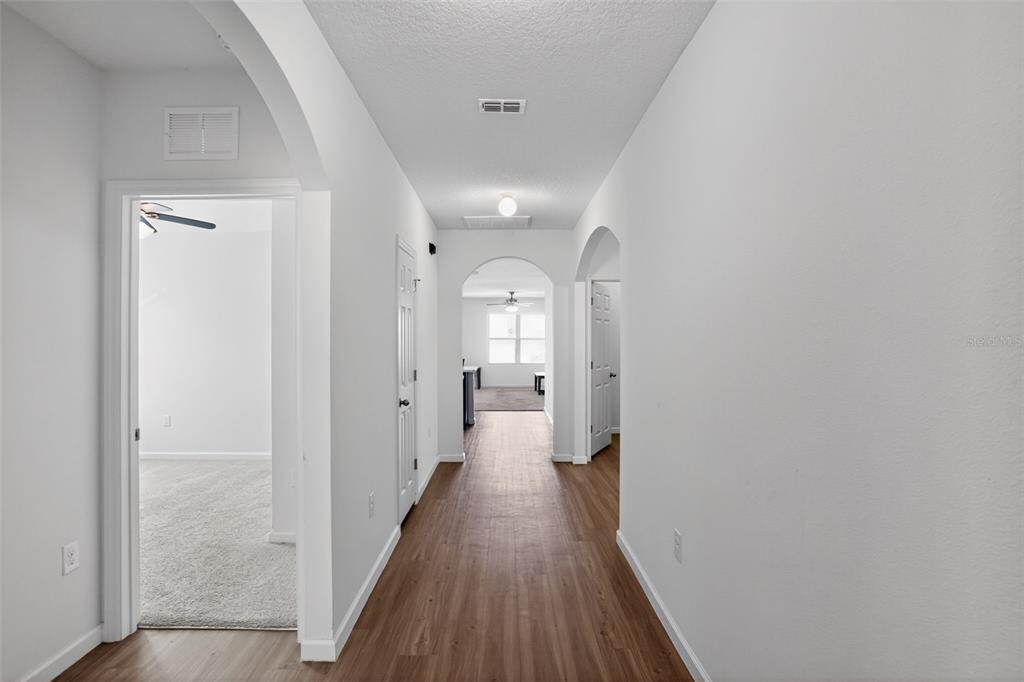 1100 Newton Circle Rockledge, FL 32955 - Photo 17 of 25 a view of a hallway with wooden floor and a bathroom