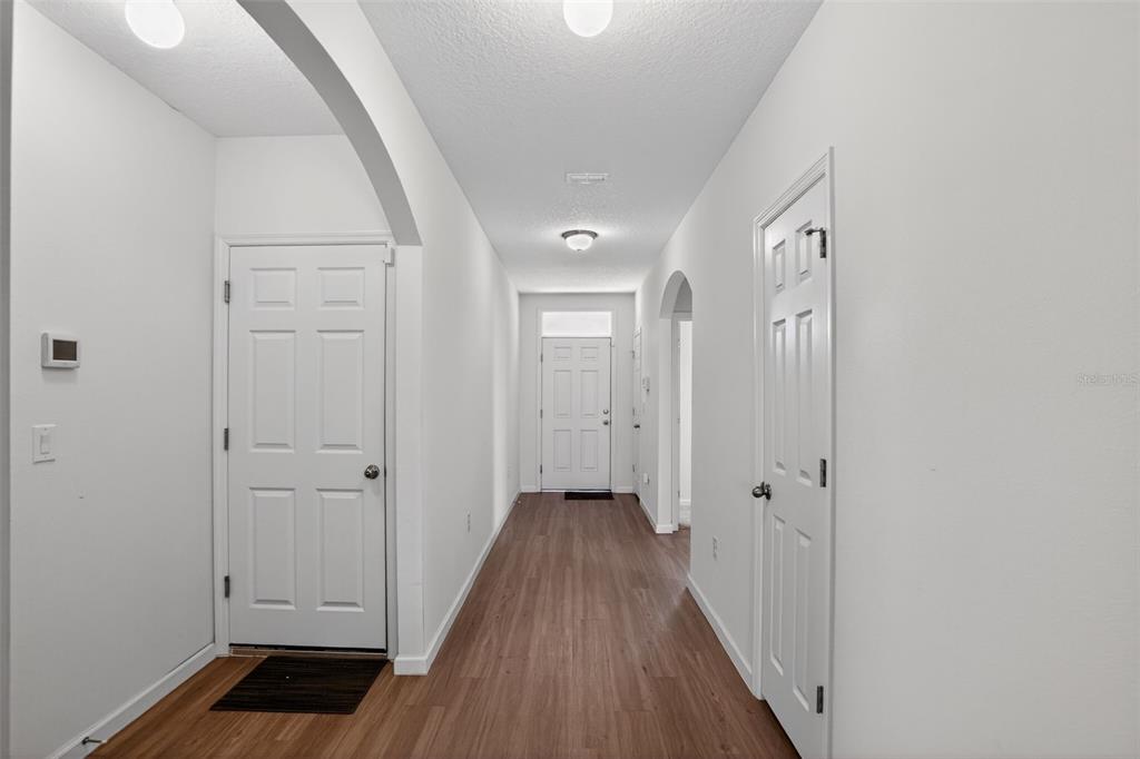 1100 Newton Circle Rockledge, FL 32955 - Photo 6 of 25 a view of a hallway with wooden floor and closet
