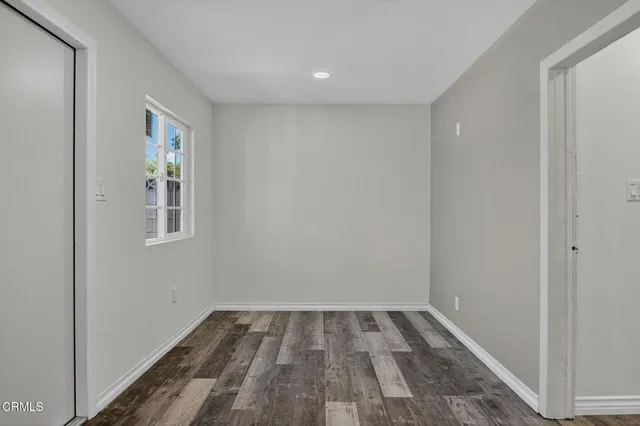 a view of room with window and wooden floor