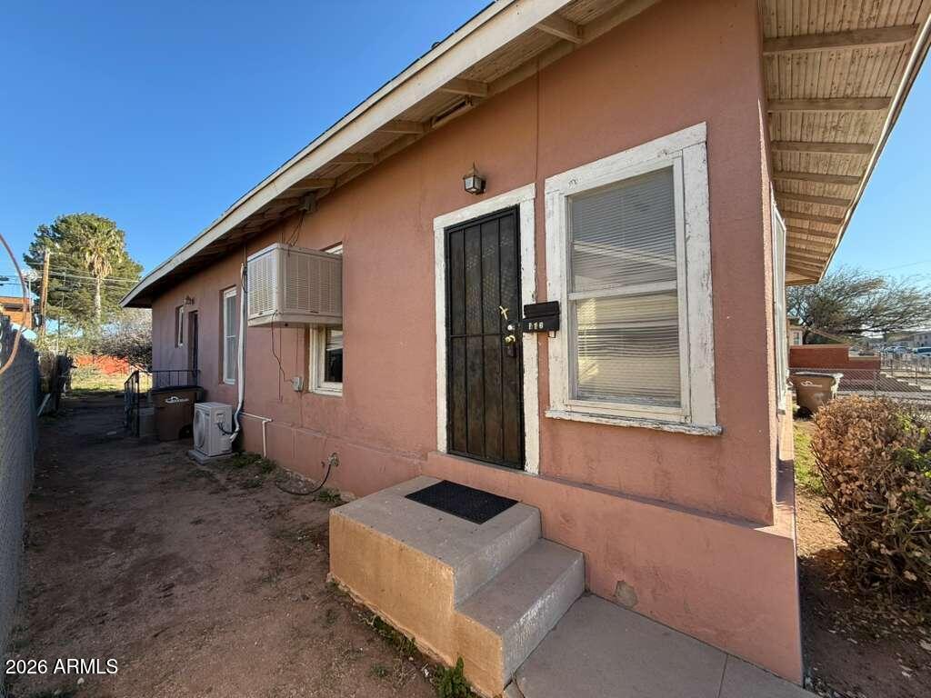 716 11th Street Douglas, AZ 85607 - Photo 1 of 26 a front view of a house with a yard