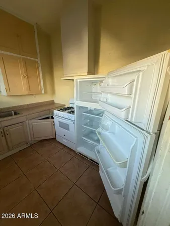 a kitchen with stainless steel appliances a sink stove and cabinets