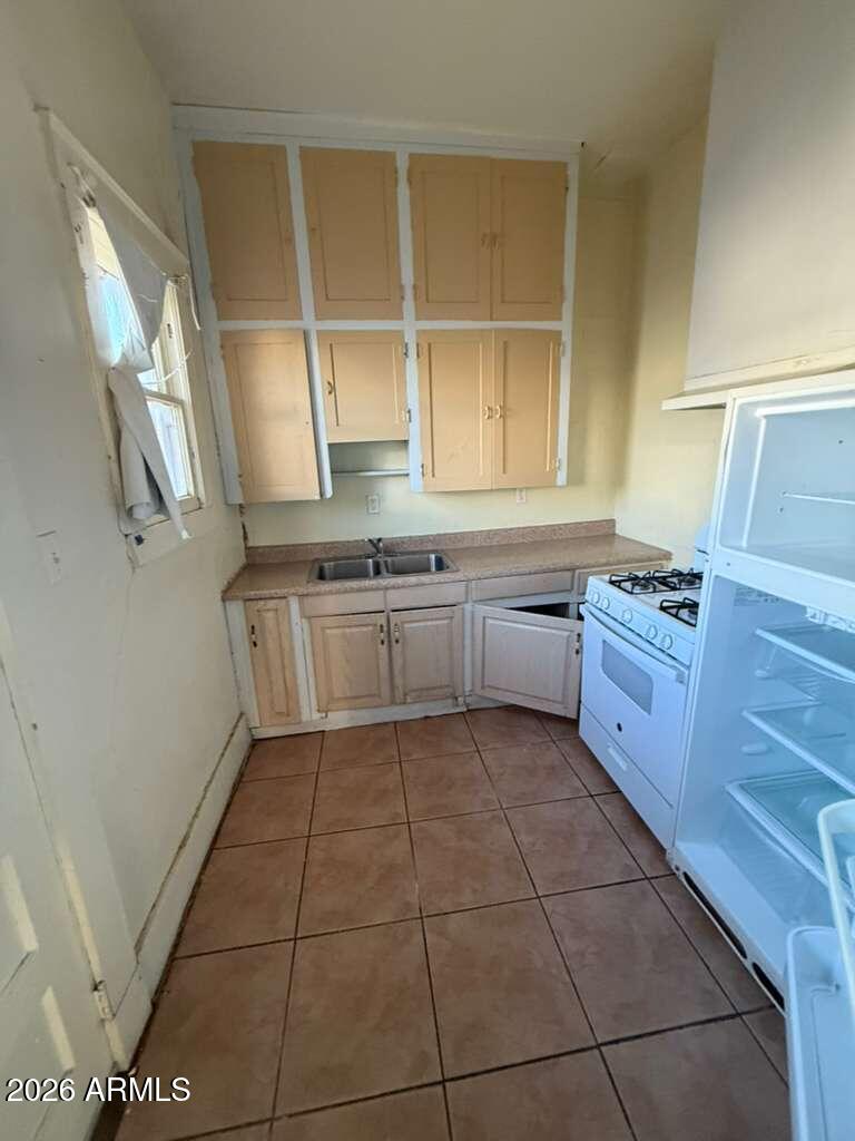 716 11th Street Douglas, AZ 85607 - Photo 12 of 26 a kitchen with stainless steel appliances a sink stove and cabinets