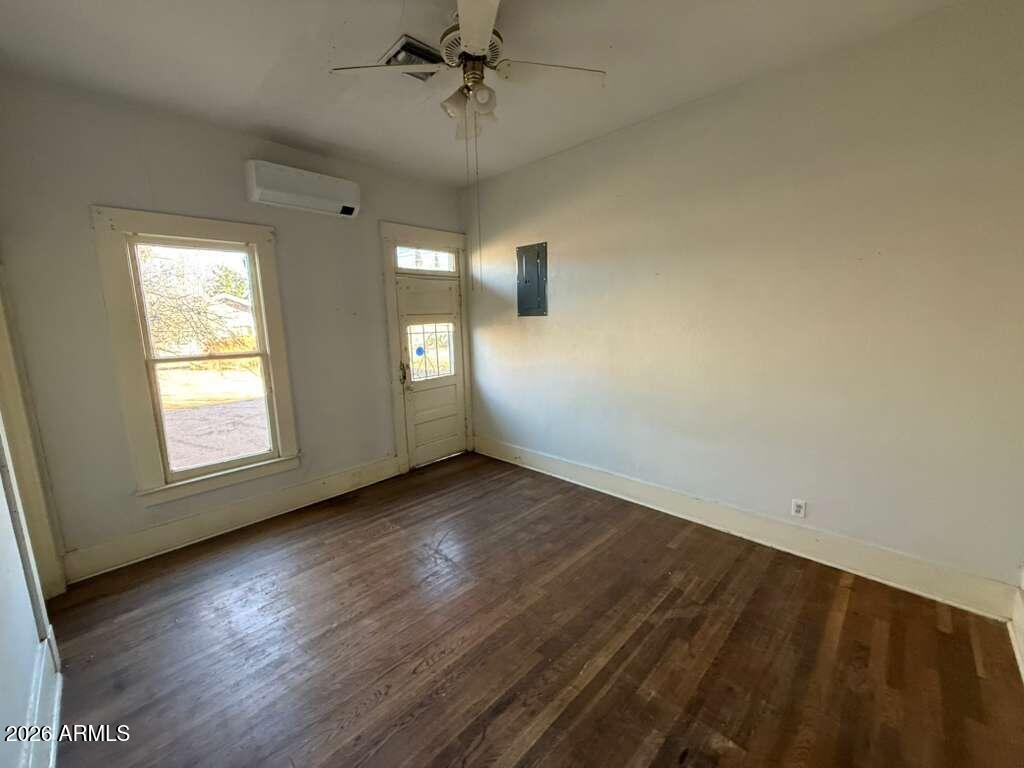 716 11th Street Douglas, AZ 85607 - Photo 17 of 26 an empty room with wooden floor fan and windows