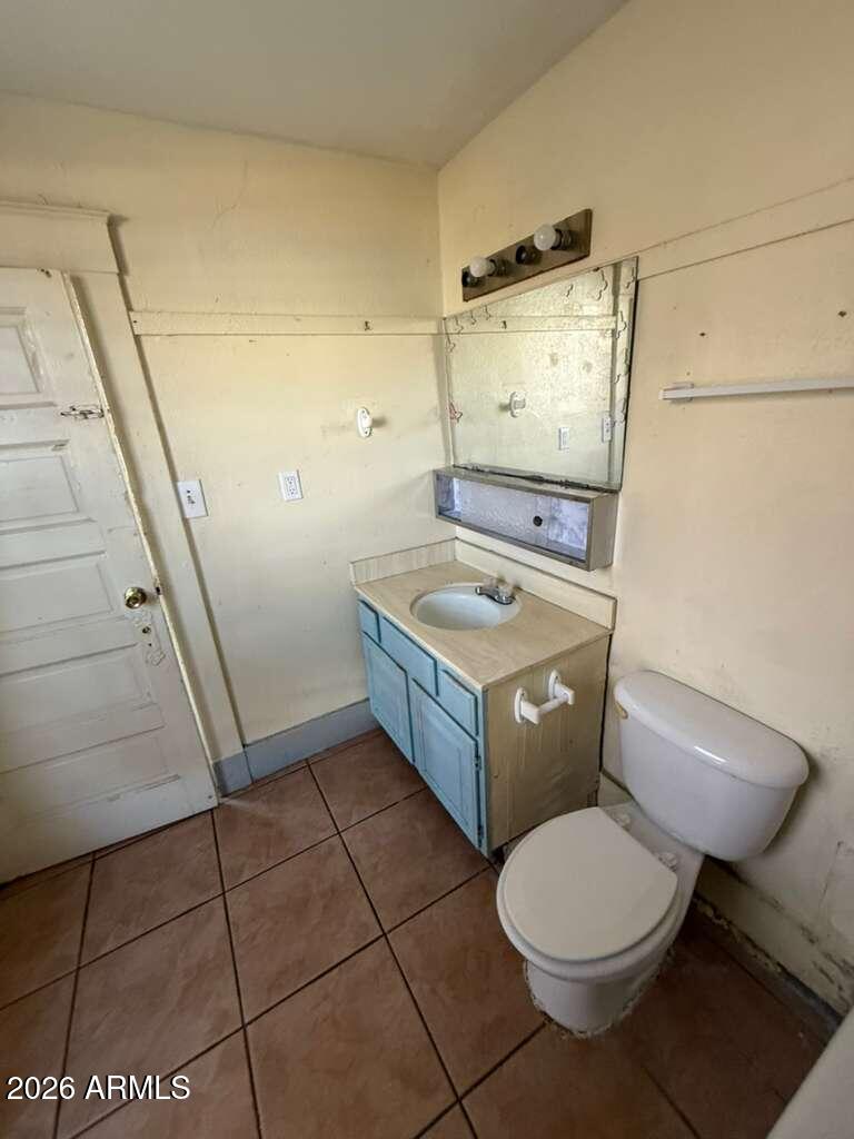 716 11th Street Douglas, AZ 85607 - Photo 20 of 26 a bathroom with a toilet a sink and a mirror