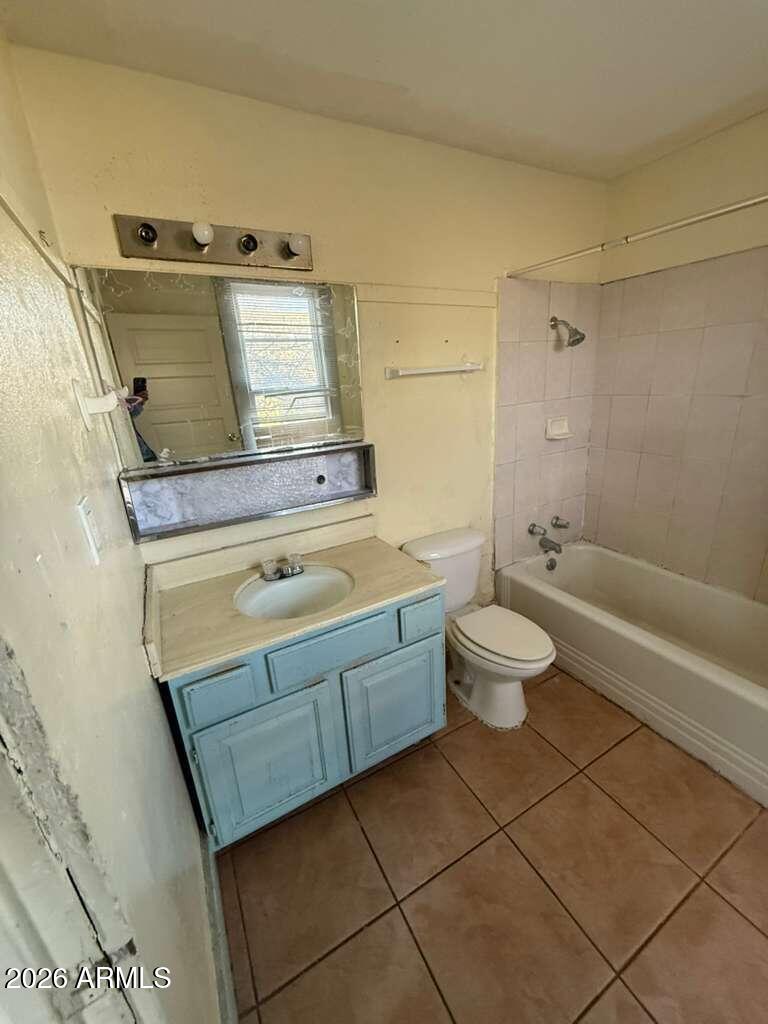 716 11th Street Douglas, AZ 85607 - Photo 21 of 26 a bathroom with a granite countertop sink a toilet and shower