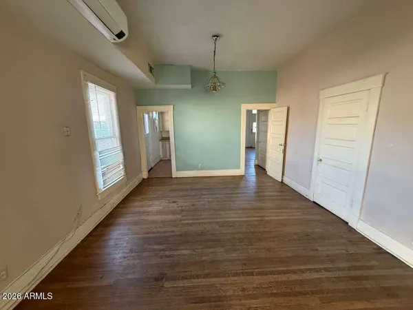 a view of a hallway with wooden floor and stairs