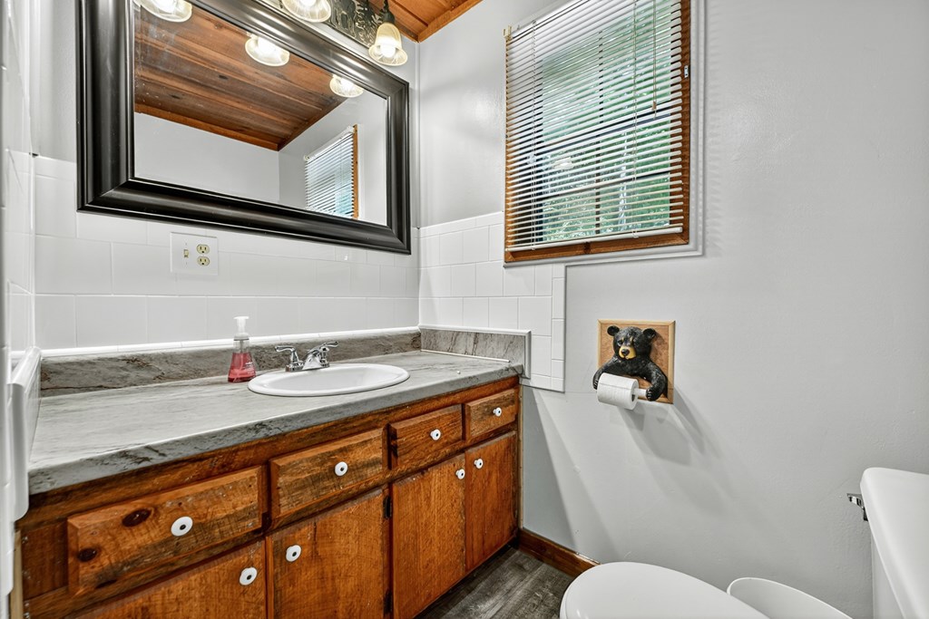 28.65 Jolley Way Epworth, GA 30541 - Photo 17 of 55 a bathroom with a granite countertop sink and a mirror