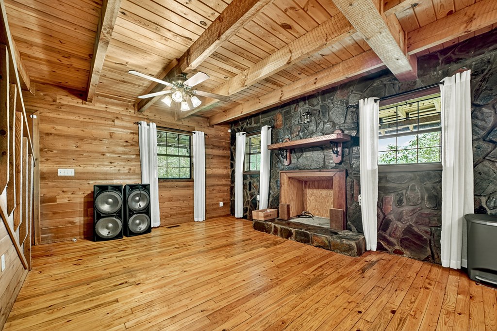 28.65 Jolley Way Epworth, GA 30541 - Photo 10 of 55 a room with gym equipment and a fireplace