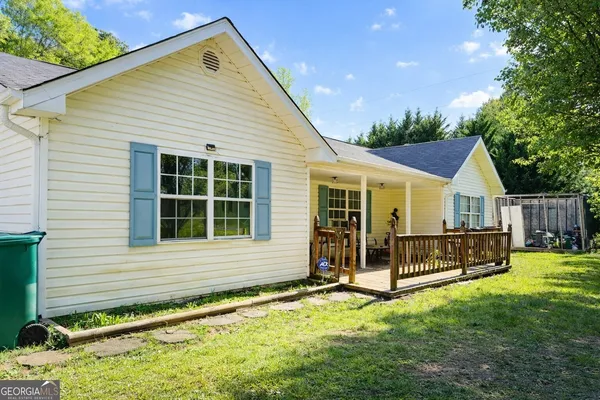 a view of an house with backyard space and balcony