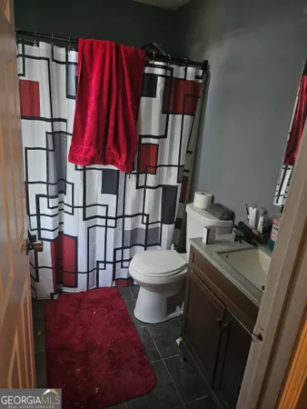 a bathroom with a toilet and a shower