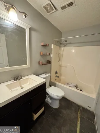 a bathroom with a double vanity sink toilet mirror and shower