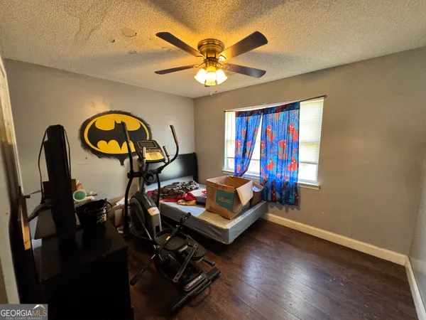 a living room with furniture a chandelier and a wooden floor