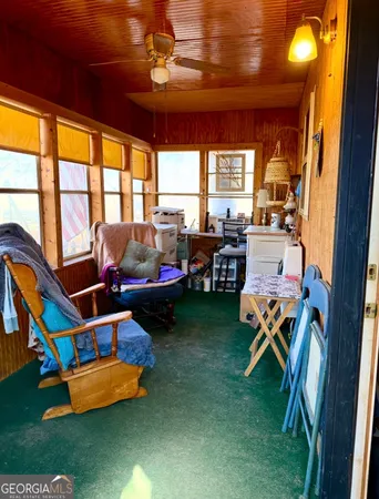 a room with furniture table and a large window