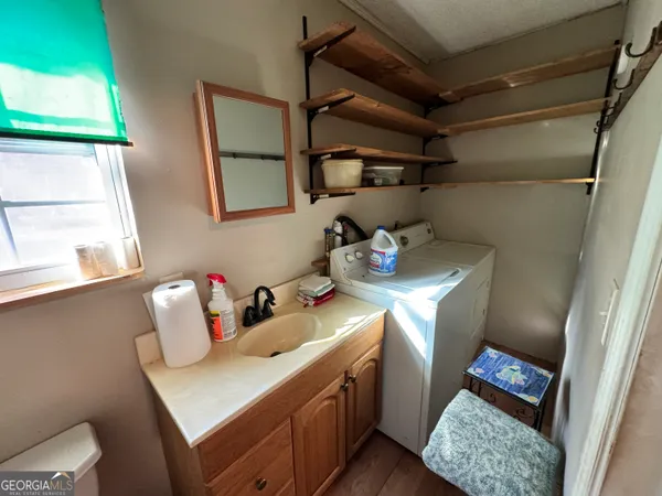 a bathroom with a sink vanity and a mirror