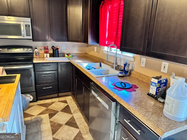 a kitchen with a sink cabinets and window