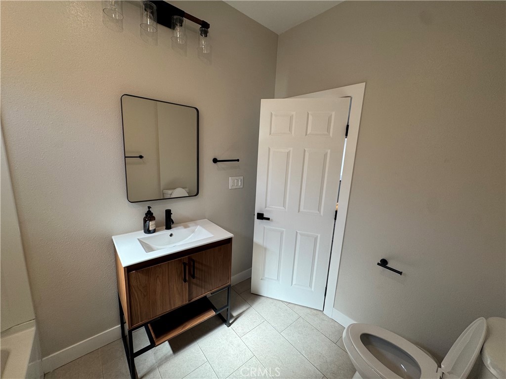 529 West 10th Street Long Beach, CA 90813 - Photo 13 of 19 a room with a mirror and a wooden floor