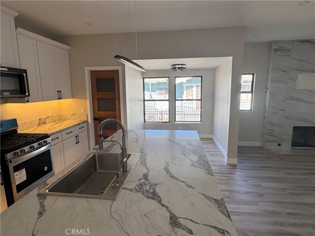529 West 10th Street Long Beach, CA 90813 - Photo 15 of 19 a view of a kitchen with a sink and cabinets