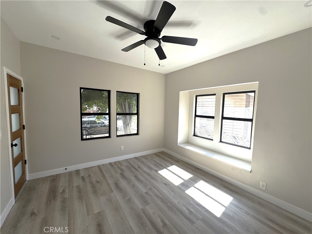 529 West 10th Street Long Beach, CA 90813 - Photo 9 of 19 a view of an empty room with a window and wooden floor