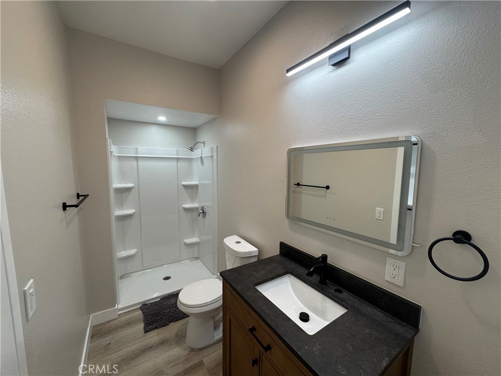 529 West 10th Street Long Beach, CA 90813 - Photo 10 of 19 a bathroom with a toilet sink shower and mirror
